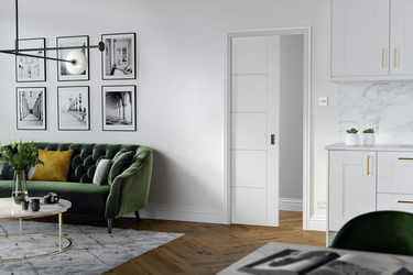 LPD Doors - Flusso Internal Door in a modern living space with green sofa and stylish decor.
